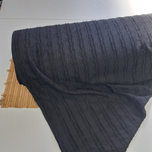 Black, 97% Polyester, 3% Spandex Textured Knit. SOLD BY HALF METERS